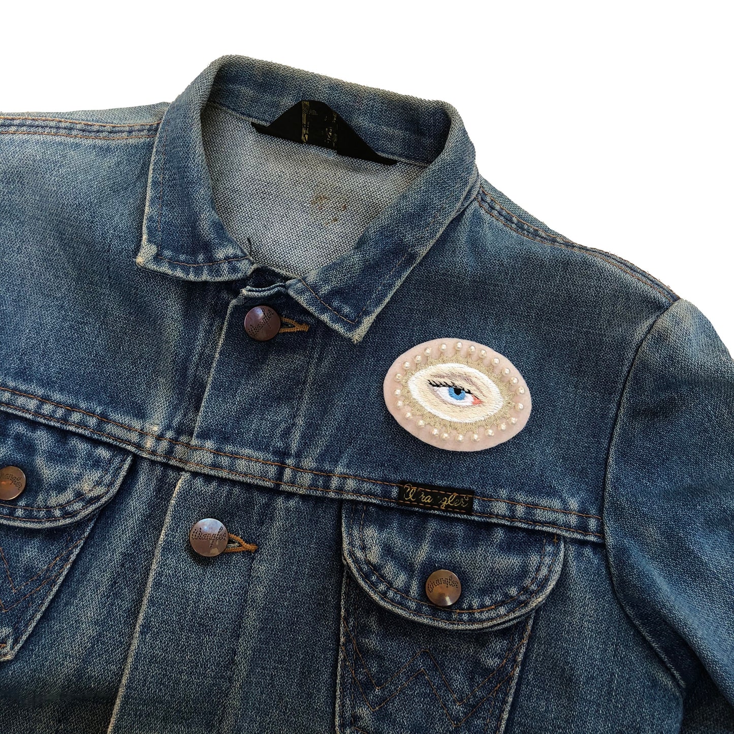 Example of lover's eye embroidered patch with on blue denim jacket