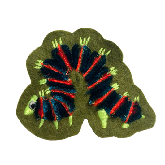 Fluffy caterpillar embroidered patch on white background