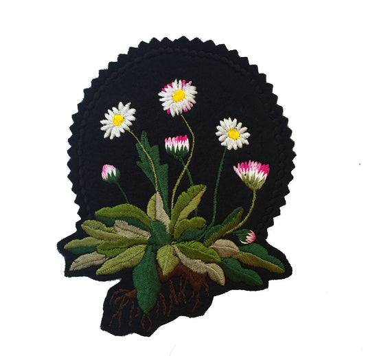 Daisy embroidered patch on white background