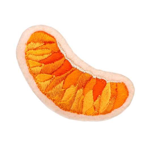 Orange slice embroidered patch on white background