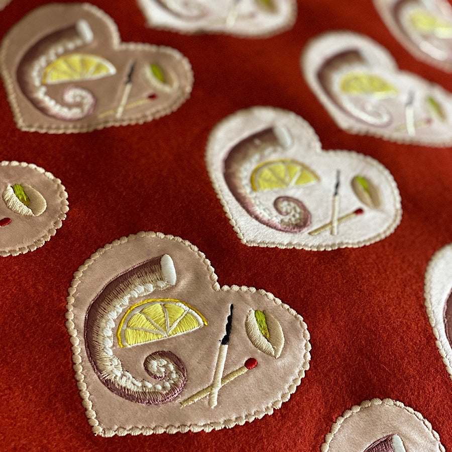 A number of uncut minature platter embroideries on rust coloured wool felt