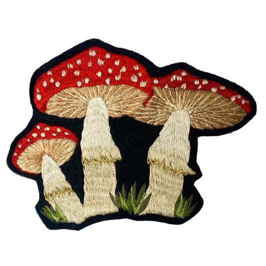Embroidered mushroom patch on a white background