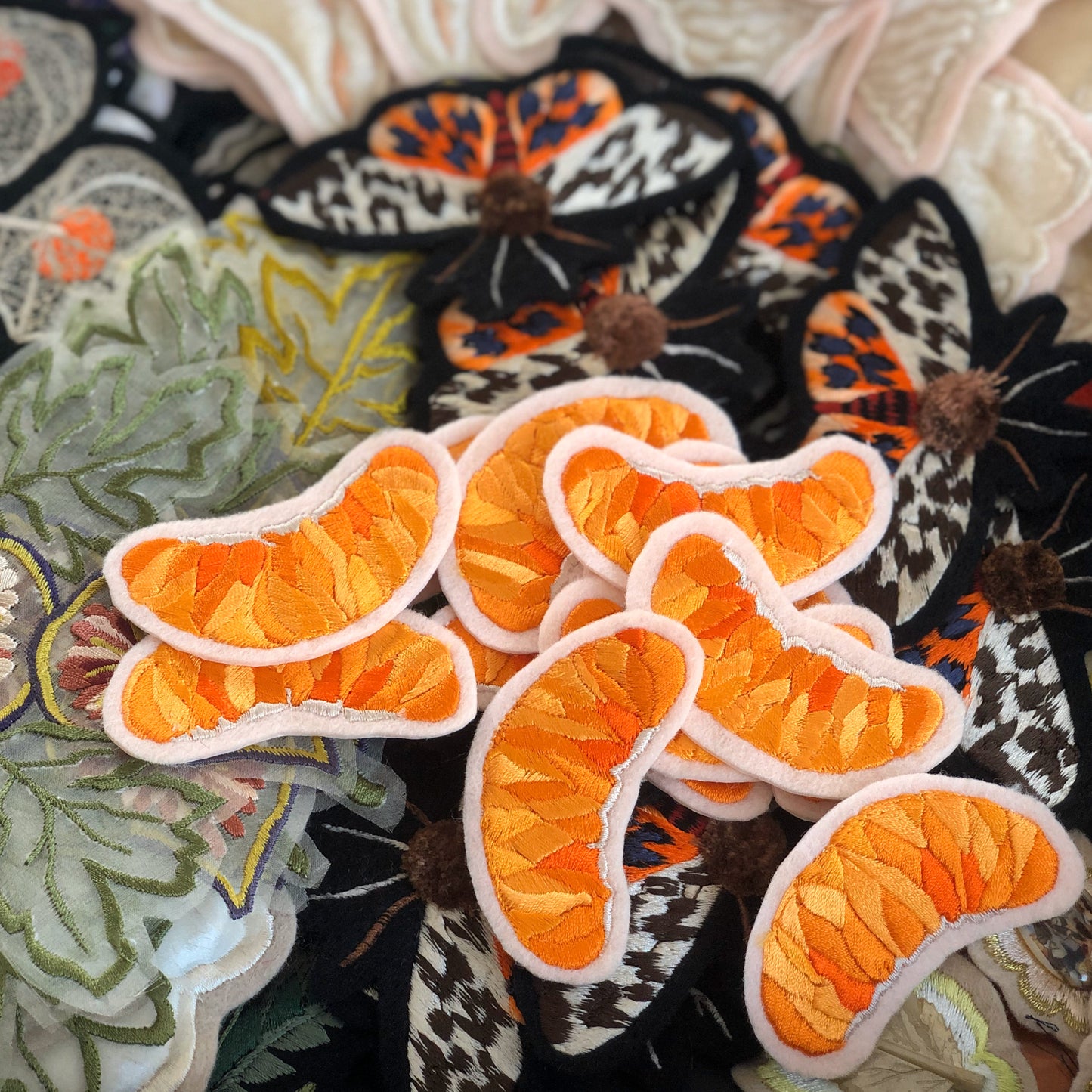 Selection of Ellie Mac Embroidery patches with the orange slice embroidered patch on the top