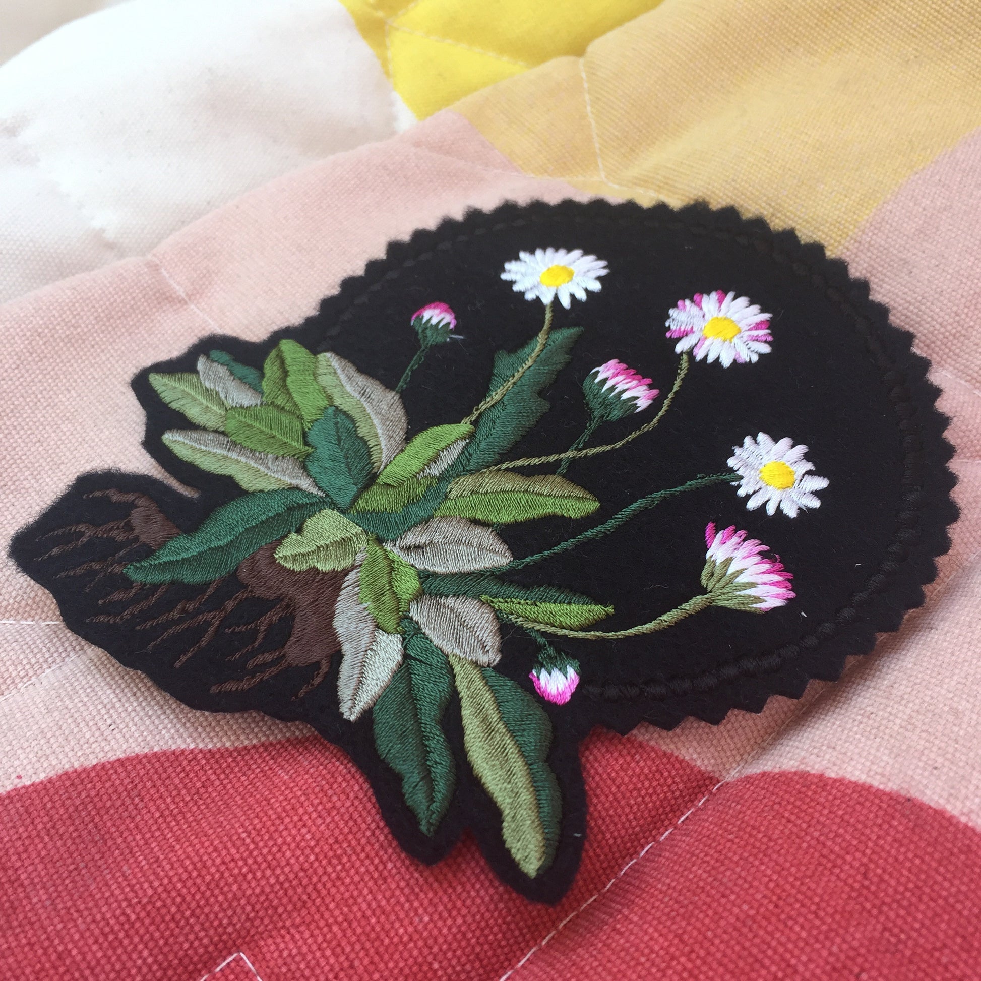 Close-up of daisy embroidered patch