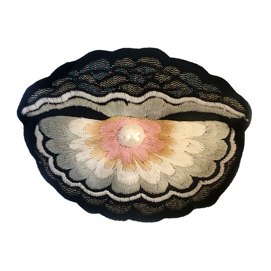 Oyster with pearl embroidered patch on a white background