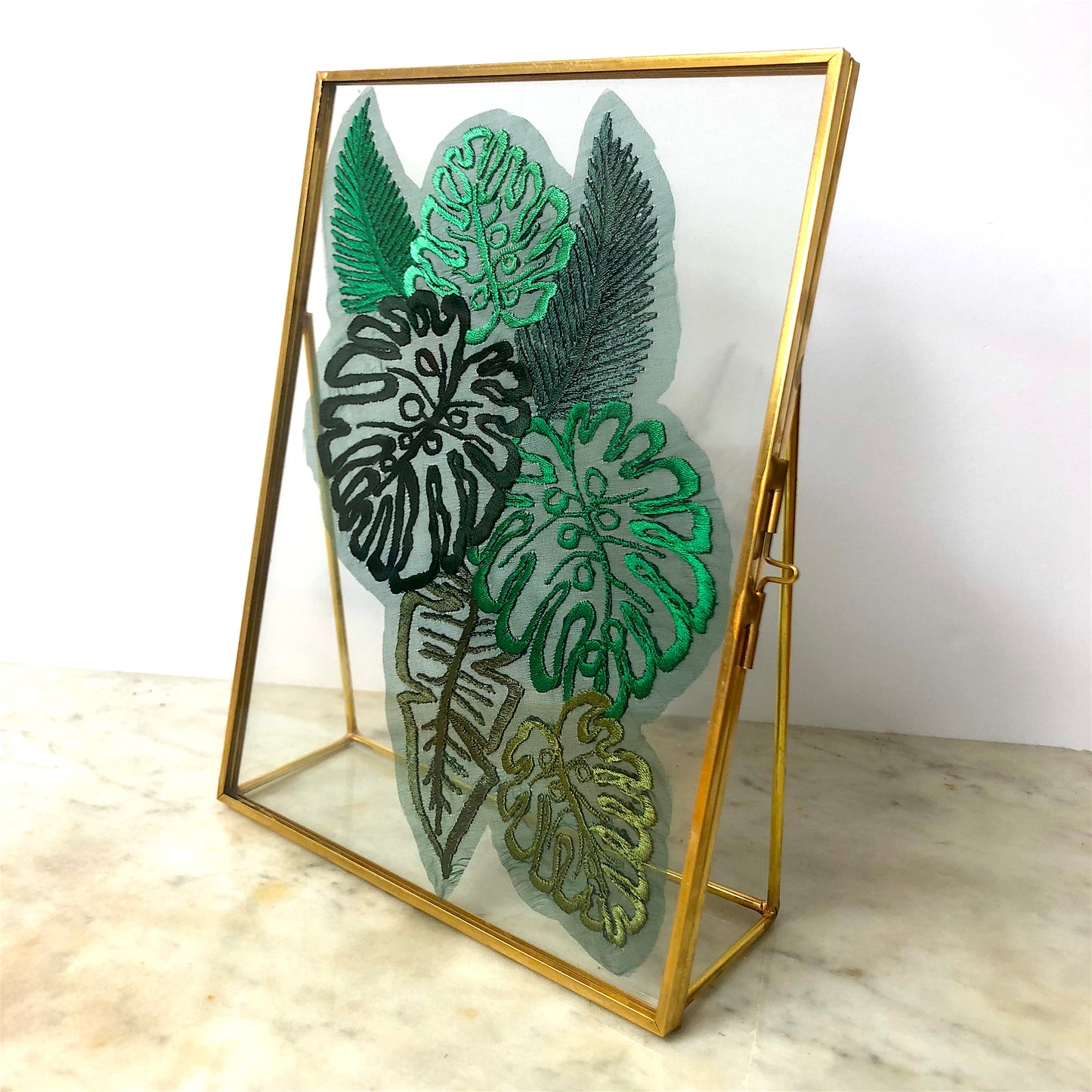 Sheer silk embroidered leaf piece shown in gold glass frame